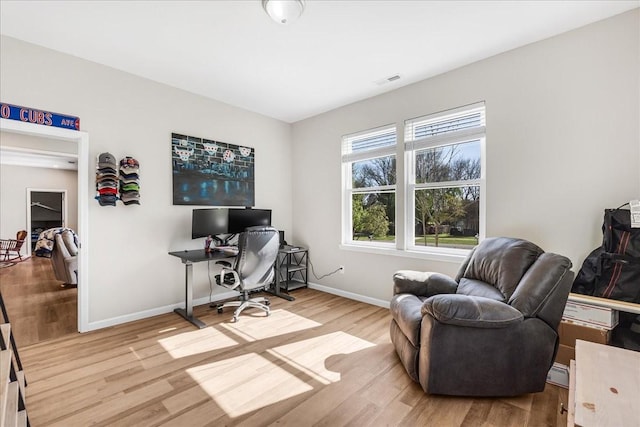 office with visible vents, baseboards, and wood finished floors