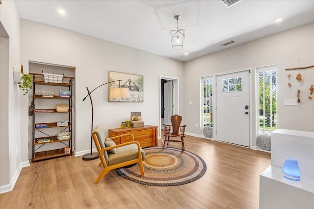 sitting room with visible vents, baseboards, recessed lighting, and wood finished floors