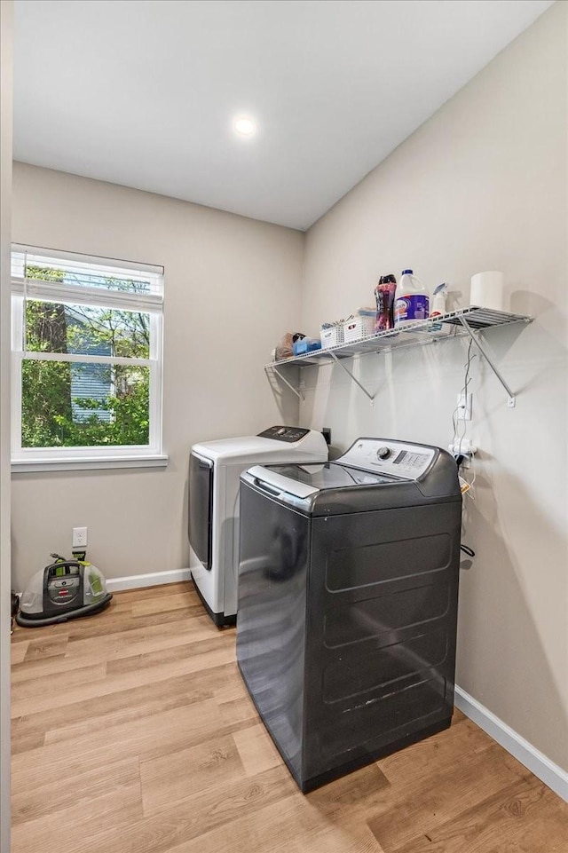 washroom with laundry area, separate washer and dryer, recessed lighting, light wood finished floors, and baseboards