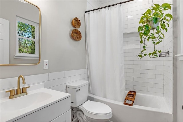 full bathroom with shower / bath combo with shower curtain, vanity, tile walls, and toilet
