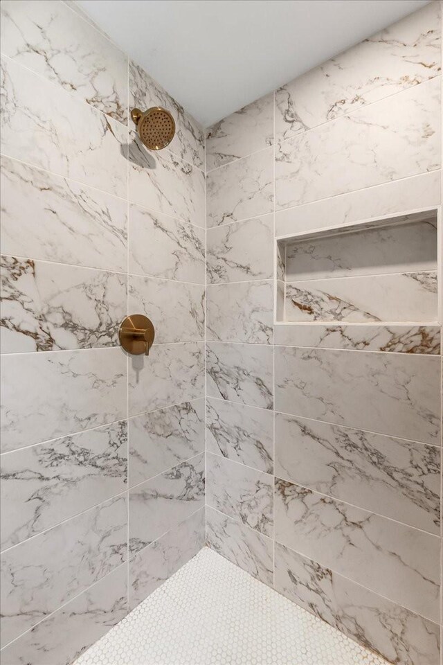 bathroom with a tile shower