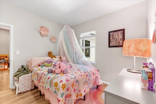 bedroom with light wood finished floors