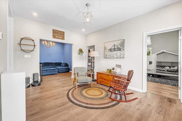 sitting room with baseboards, recessed lighting, and wood finished floors