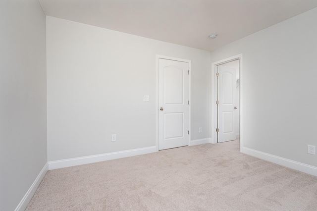 unfurnished room featuring baseboards and carpet floors