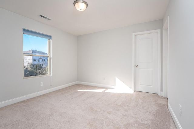 unfurnished room featuring carpet, baseboards, and visible vents
