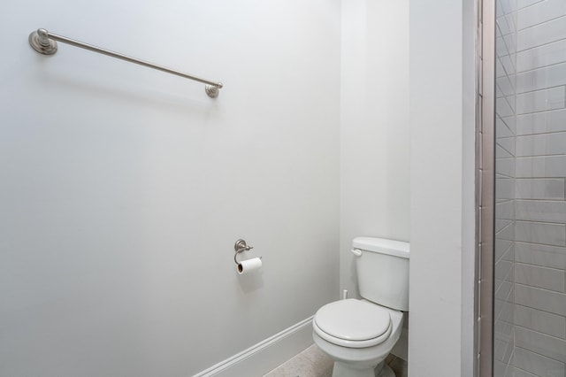bathroom featuring baseboards and toilet