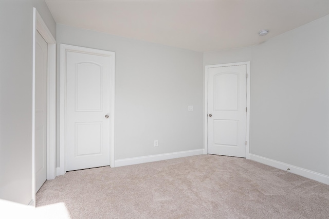 interior space with baseboards and carpet flooring