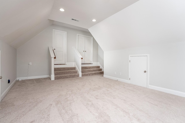 additional living space featuring visible vents, carpet, baseboards, recessed lighting, and vaulted ceiling