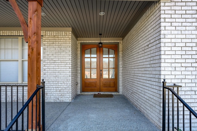 entrance to property featuring brick siding and french doors