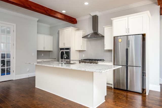 kitchen with beamed ceiling, a kitchen island with sink, stainless steel appliances, dark wood-type flooring, and wall chimney range hood