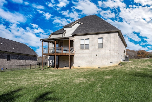 rear view of property with brick siding, crawl space, fence, and a lawn