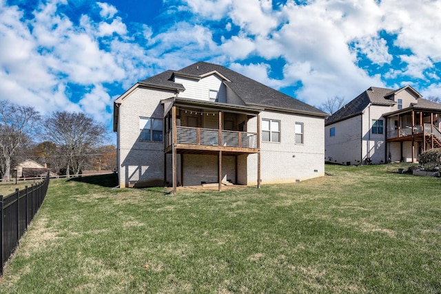 rear view of house with brick siding, fence, crawl space, and a yard