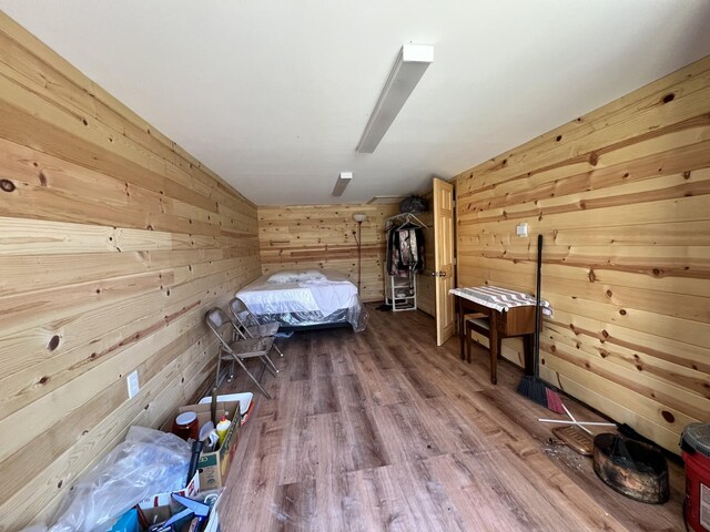 3795 Wayland Springs Rd, Iron City, TN 38463 - unfurnished bedroom with wood walls, a ceiling fan, and wood finished floors