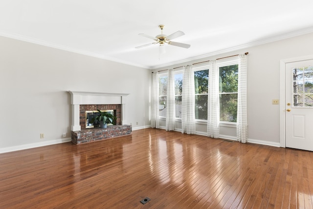 812 Deer Foot Ct, Nashville, TN 37221 - unfurnished living room with a brick fireplace, hardwood / wood-style flooring, baseboards, ornamental molding, and ceiling fan