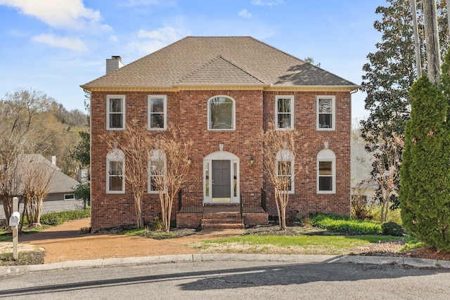 812 Deer Foot Ct, Nashville, TN 37221 - view of front of home featuring brick siding, a shingled roof, and a chimney