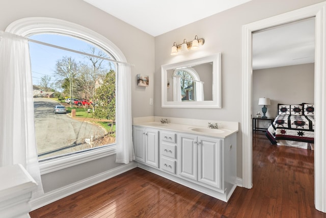 812 Deer Foot Ct, Nashville, TN 37221 - bathroom featuring double vanity, baseboards, a sink, and hardwood / wood-style floors
