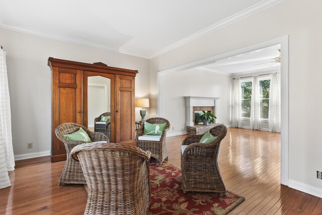 812 Deer Foot Ct, Nashville, TN 37221 - sitting room with a brick fireplace, baseboards, ornamental molding, and hardwood / wood-style floors