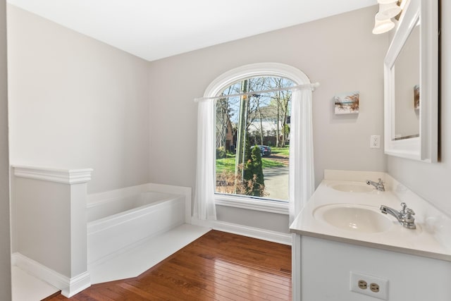 812 Deer Foot Ct, Nashville, TN 37221 - full bathroom with baseboards, a sink, a garden tub, and hardwood / wood-style flooring