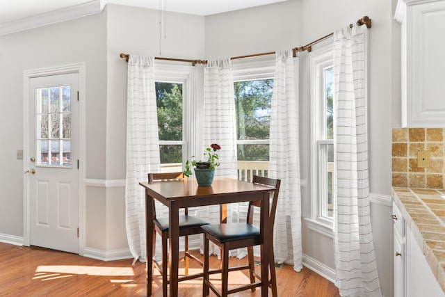 812 Deer Foot Ct, Nashville, TN 37221 - dining space with baseboards, light wood-style floors, crown molding, and plenty of natural light