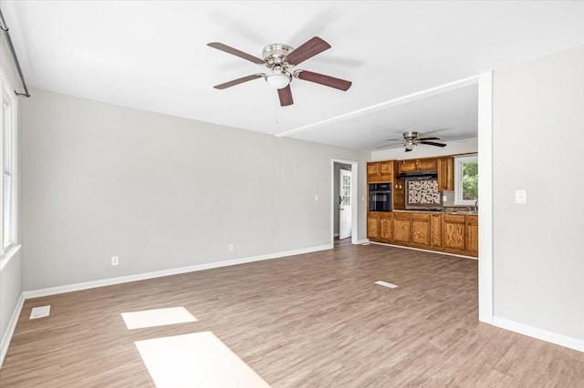 1309 Ovoca Rd, Tullahoma, TN 37388 - unfurnished living room featuring wood finished floors, baseboards, and a ceiling fan