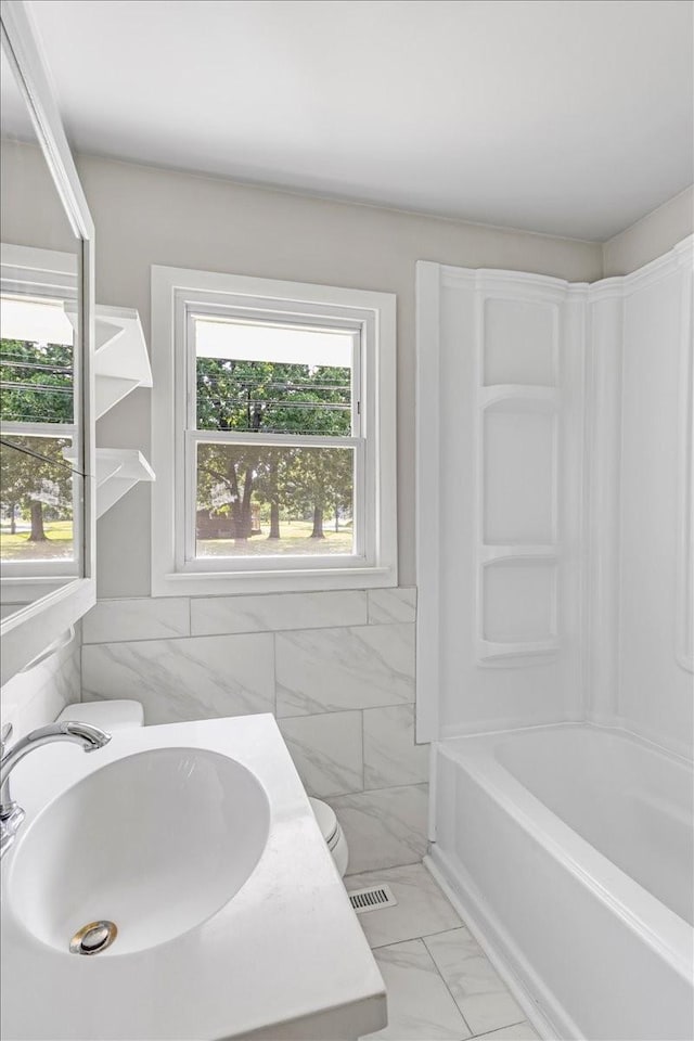 1309 Ovoca Rd, Tullahoma, TN 37388 - full bathroom with marble finish flooring, a sink, tub / shower combination, and toilet
