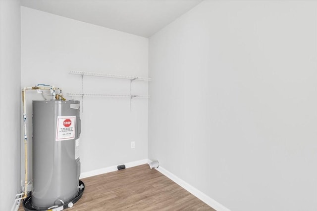 1309 Ovoca Rd, Tullahoma, TN 37388 - washroom with electric water heater, wood finished floors, and baseboards