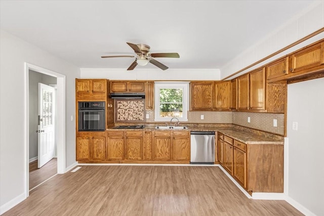 1309 Ovoca Rd, Tullahoma, TN 37388 - kitchen featuring black oven, stainless steel dishwasher, a sink, a ceiling fan, and tasteful backsplash