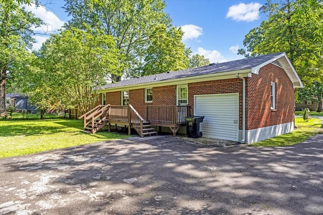1309 Ovoca Rd, Tullahoma, TN 37388 - view of front of property with brick siding, a front yard, a deck, and asphalt driveway