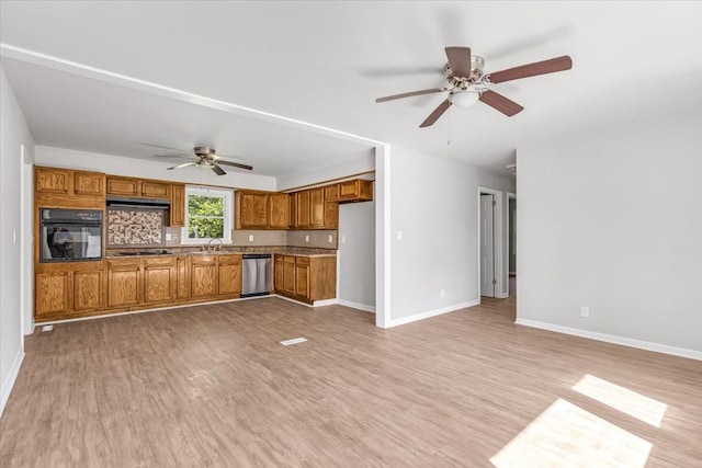 1309 Ovoca Rd, Tullahoma, TN 37388 - kitchen with black oven, dishwasher, a ceiling fan, brown cabinets, and under cabinet range hood