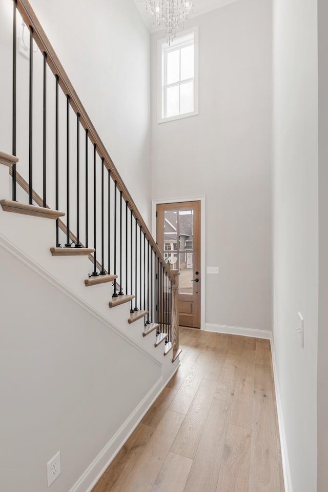 3180 Long Branch Cir, Franklin, TN 37064 - entrance foyer featuring stairs, baseboards, a chandelier, a towering ceiling, and wood finished floors