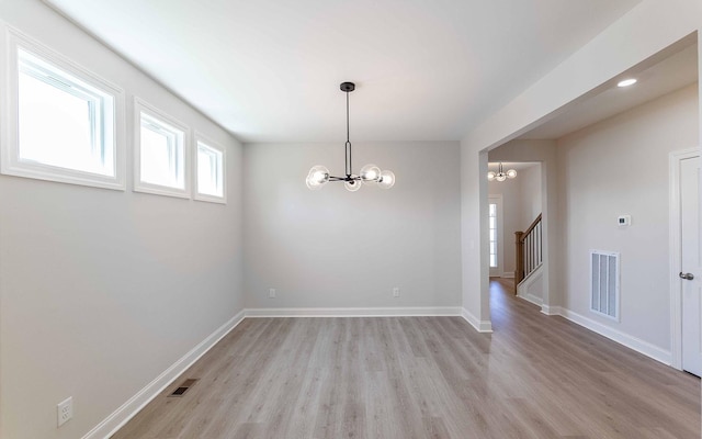 156 John T Alexander Blvd, Hendersonville, TN 37075 - empty room featuring a chandelier, light wood-style flooring, baseboards, and stairs