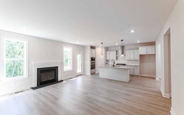 156 John T Alexander Blvd, Hendersonville, TN 37075 - kitchen with stainless steel appliances, white cabinetry, light wood-style flooring, tasteful backsplash, and recessed lighting