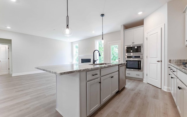 156 John T Alexander Blvd, Hendersonville, TN 37075 - kitchen with stainless steel appliances, a sink, a fireplace, light wood-style flooring, and recessed lighting