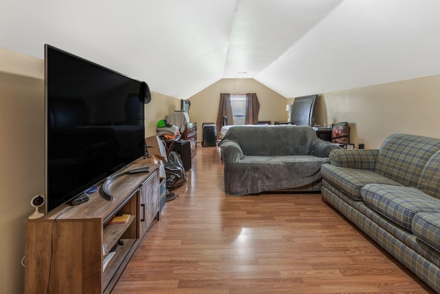 living room with light wood-style flooring and vaulted ceiling