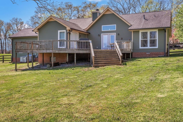 rear view of property with stairs, a shingled roof, fence, and a yard