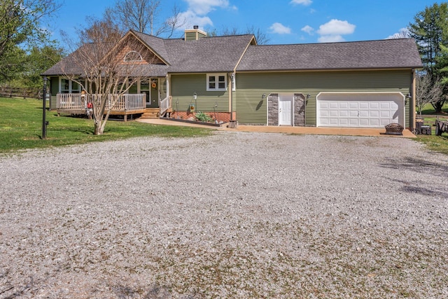 ranch-style house with driveway, a front yard, roof with shingles, a chimney, and a garage
