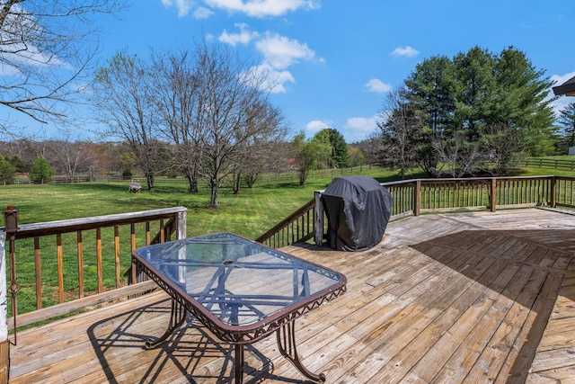 wooden terrace featuring a fenced backyard, outdoor dining space, area for grilling, and a yard
