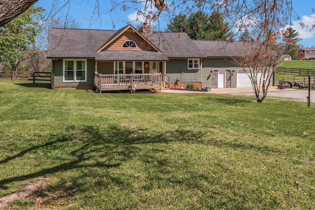 view of front of property featuring fence, a chimney, a front yard, roof with shingles, and driveway