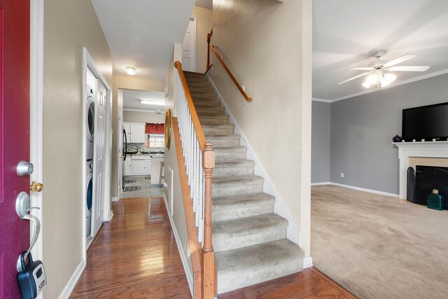 4009 Wellington Ct, Old Hickory, TN 37138 - entrance foyer featuring stacked washer and clothes dryer, stairs, a ceiling fan, wood finished floors, and a fireplace