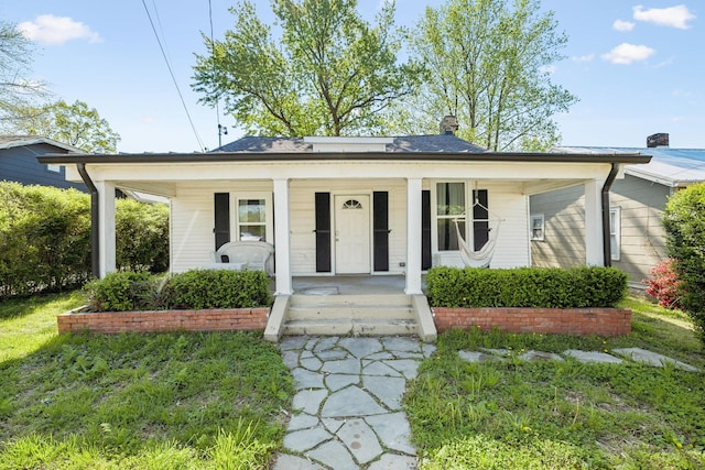 bungalow with a chimney and covered porch