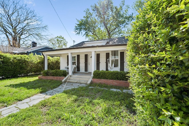 bungalow-style home featuring a porch and a front yard