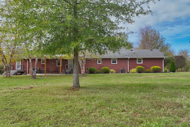1935 Liberty Ln, Gallatin, TN 37066 - rear view of house featuring a patio area, brick siding, and a lawn