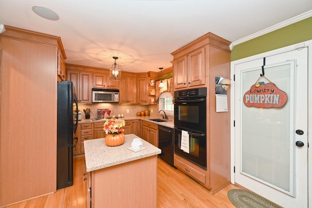 1935 Liberty Ln, Gallatin, TN 37066 - kitchen with light wood-style floors, tasteful backsplash, black appliances, a center island, and a sink