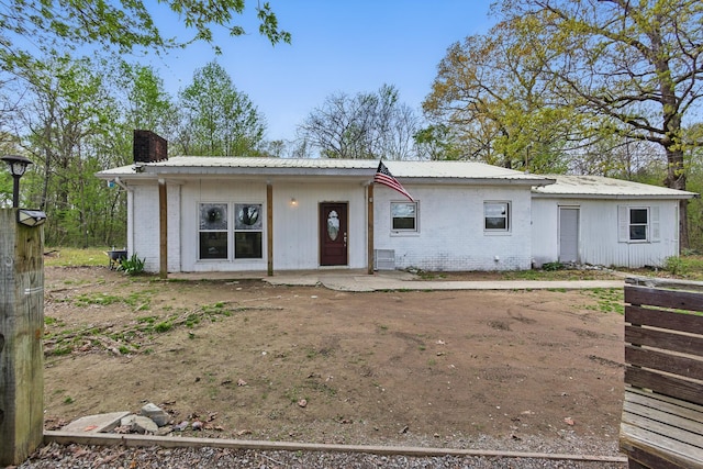 12 Dukes Ln, Kelso, TN 37348 - view of front of house with a chimney, metal roof, and brick siding