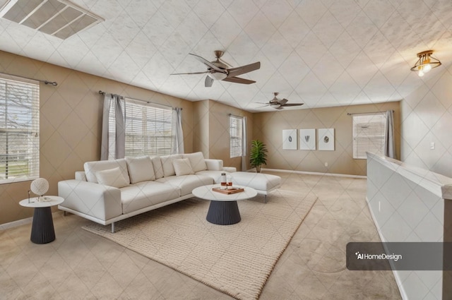 living area featuring a ceiling fan and visible vents