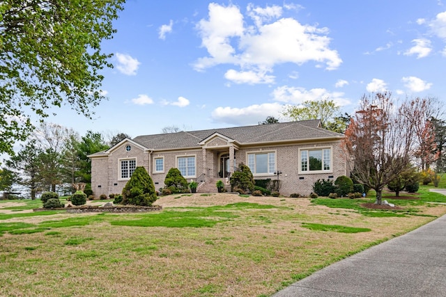 ranch-style house with a front lawn and brick siding