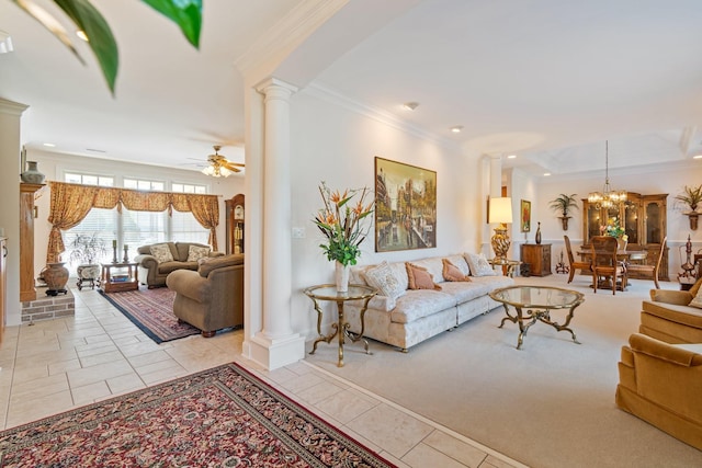 living area featuring light tile patterned floors, ornamental molding, decorative columns, recessed lighting, and ceiling fan with notable chandelier