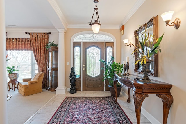 entryway featuring visible vents, baseboards, crown molding, ornate columns, and light tile patterned flooring