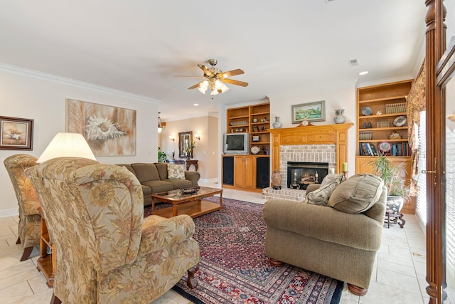 living area with ceiling fan, a fireplace, light tile patterned floors, ornamental molding, and built in shelves