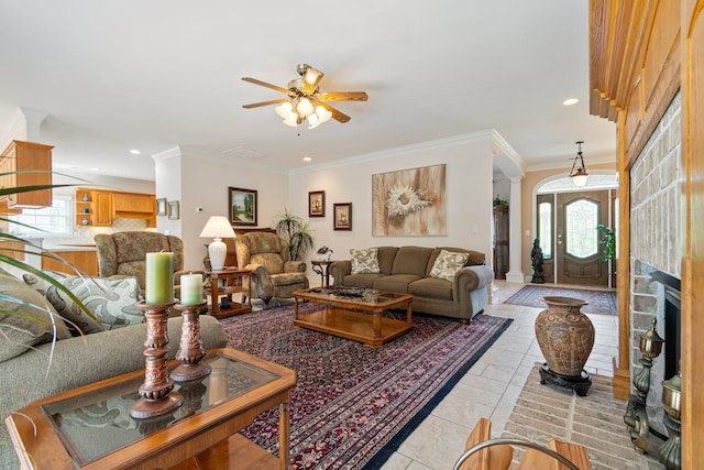 living room featuring crown molding, light tile patterned floors, a ceiling fan, and recessed lighting